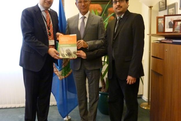 Marc-Michael Blum (left) and R.V.S. Murty Mamidanna (right), Senior Analytical Chemists in the OPCW Laboratory, present a copy of the special edition of Analytical & Bioanalytical Chemistry to OPCW Director-General Ahmet Üzümcü (center).