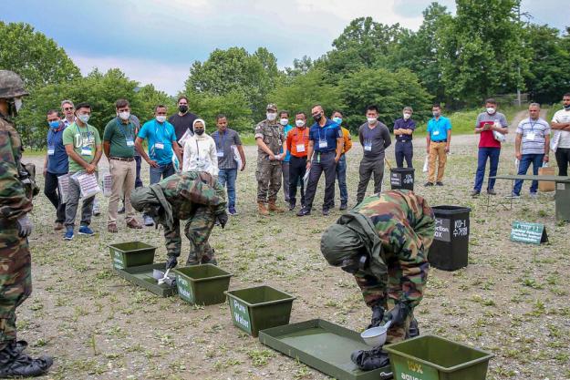 Participants observe decontamination of PPE shoes.