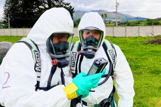 Training participants consult detection equipment during the simulated chemical emergency.