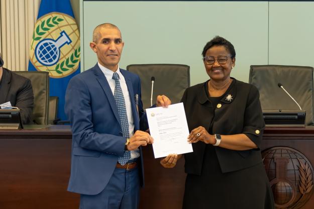 Mr Fareh Merdj, Deputy Director Physics Chemistry at NICC/GM, (left) receives an OPCW Designated Laboratory certificate on behalf of Algeria’s National Institute of Criminalistics and Criminology from Ambassador Odette Melono, OPCW Deputy Director-General (right)