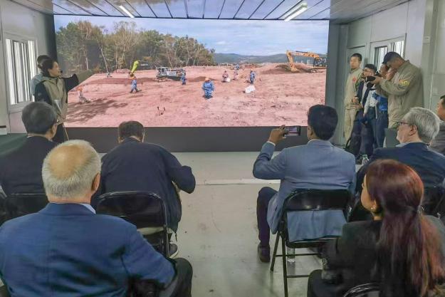 Members and observers of the OPCW Executive Council receive a briefing at the abandoned chemical weapons excavation and recovery site in Mudanjiang, China.