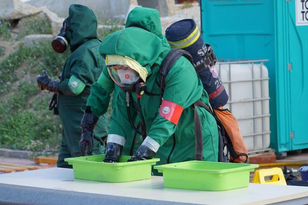 Training participant practices decontaminating when exiting the mock chemical hot zone.
