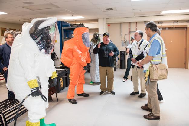 Carl Reagan (center), explains various levels of personal protective equipment to members of the Organisation for the Prohibition of Chemical Weapons Executive Council during a tour of the Blue Grass Chemical Agent-Destruction Pilot Plant June 13.