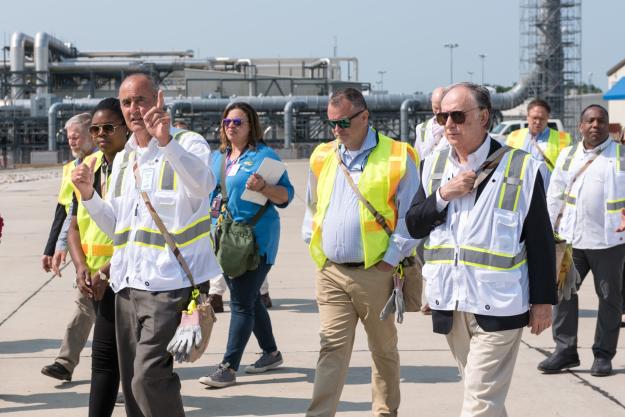 Michael Abaie, Assembled Chemical Weapons Alternatives program executive officer, points to areas at the Static Detonation Chamber 2000 as members of the Organisation for the Prohibition of Chemical Weapons Executive Council tour the Blue Grass Chemical Agent-Destruction Pilot Plant June 13.