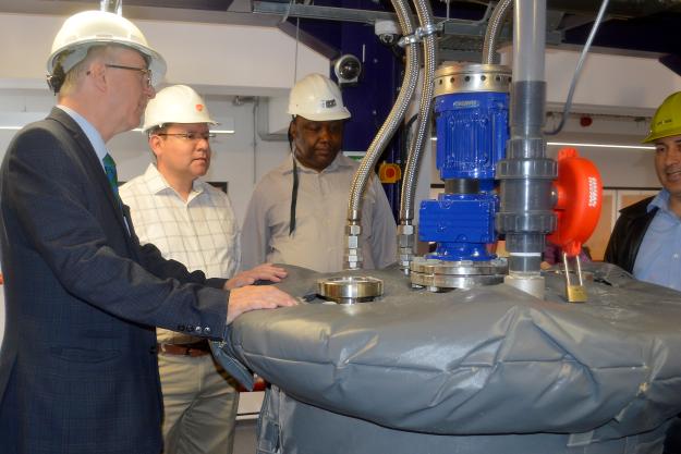 Participants listen to an explanation of a chemical process at the University of Surrey pilot plant