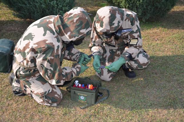 Participants conduct detection, identification and monitoring activities during a chemical emergency response exercise held as part of a training course in Islamabad, Pakistan.