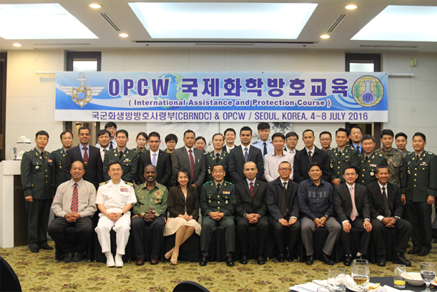 Participants at the Advanced Training Course for Police First Responders from Asia, which was held in Seoul, Republic of Korea from 4-8 July 2016.A course participant is checked for contamination as part of the training exercise for first responders. If this were a real event, both participants would be in protective gear.