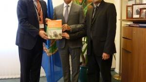 Marc-Michael Blum (left) and R.V.S. Murty Mamidanna (right), Senior Analytical Chemists in the OPCW Laboratory, present a copy of the special edition of Analytical & Bioanalytical Chemistry to OPCW Director-General Ahmet Üzümcü (center).